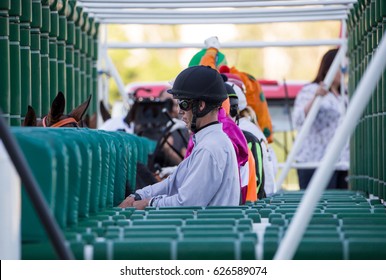 Jockeys Preparing For The Horse Race In Paddock Before Start.