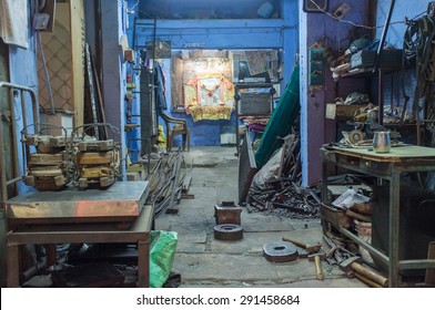 JODHPUR, INDIA - 17 FEBRUARY 2015: Empty Mechanics Shop With Small Shiva Temple In Background.