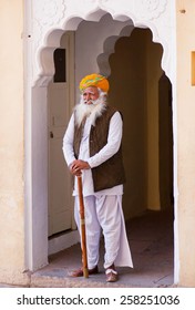 JODHPUR, INDIA - JAN 21: Elderly Man In Traditional Rajasthan Clothes And Turban Stands In Doorway Of Indian Palace On January 21 2015. Jodhpur, With Population 1,290,000, Is A Center Of Marwar Region