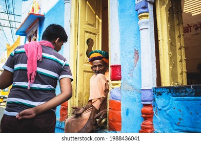 Jodhpur, Rajasthan, India - April14, 2015: Elderly Man Sitting In Doorway Of Colorful House