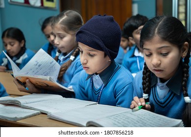 Jodhpur, Rajasthan, India - Jan 10th 2020: Primary Indian Students Studying In The Classroom Taking Exam / Test Writing In Notebooks. Education Concept.