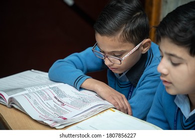 Jodhpur, Rajasthan, India - Jan 10th 2020: Primary Indian Students Studying In The Classroom Taking Exam  Test Writing In Notebooks. Education Concept.