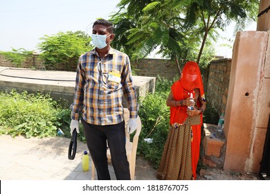 Jodhpur, Rajasthan, India, September 13,2020: Seutiry Guard With Metal Detector And Woman With Sanitizer Wearing Mask Standing At School Entrance Waiting For Students To Come, Safety COVID-19