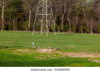 A Jogger Runs Through An Open Field In Shelby County, Tn. On Apr. 10th 2022.