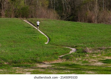 A Jogger Runs Through An Open Field In Shelby County, Tn. On Apr. 10th 2022.