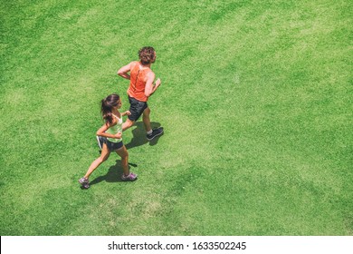 Jogging Couple Athletes Runners Running People On Grass Park Top View From Above Aerial Drone. Summer Fitness Active Lifestyle Fit People Training Hiit Workout Cardio.