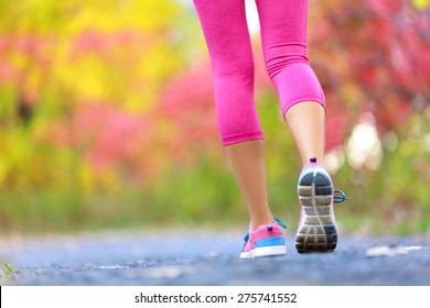 Jogging- und Lauffrau mit sportlichen Beinen auf Joggen oder Laufsteg im Wald in einem gesunden Lifestyle-Konzept mit Nahaufnahme auf Laufschuhen. Im Herbst 2010 wird der weibliche Sportler Jogging und Training im Freien absolvieren.
