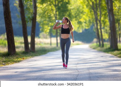 Jogging woman with a bottle of water