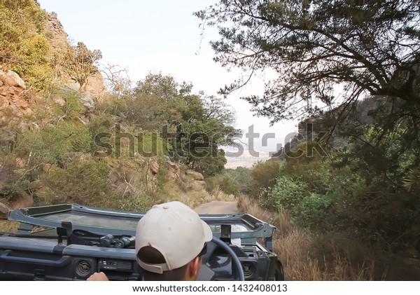 Johannaesburg,\
Gauteng South Africa 10092010 wildlife ranger driving a open roof\
car in the wild Africa\
conservation