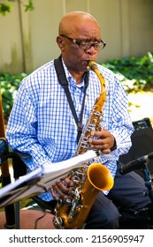 JOHANNE, SOUTH AFRICA - Apr 13, 2022: An African Jazz Musician Playing Musical Sax Instrument Outside In Johannesburg, South Africa