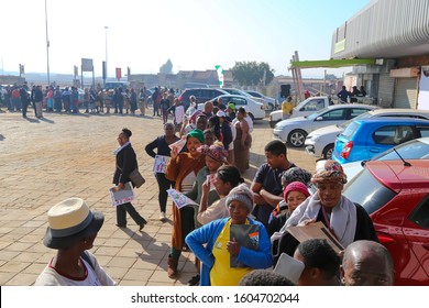 Johannesburg Gauteng South Africa 07 30 2019 Customers In A Row Waiting On Store To Open In Parking Lot With Out Of Focus Background Covid-19 Corona Virus Pandemic Township Food Shortage Panic Buy