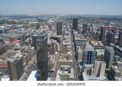 Johannesburg, Gauteng/South Africa - December 24 2017: From An Aerial View, There Is A Skyline Of The Gold Mining City With Tall Rise Buildings, Businesses And Blue Sky