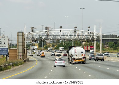 Johannesburg - January 20, 2020:cars,vehicles Travelling On A Highway And About To Pass Under An Open Road Tolling Gantry That Spans The Road For E-toll Collection. Selective Focus On The Tanker Truck