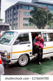 Johannesburg, South Africa,  7 September - 2018: Mini Bus Taxi With Passenger Climbing Out.