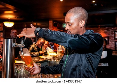 Johannesburg, South Africa - April 24, 2012: African Barman Pouring A Pint Draft Beer At Barman Training School