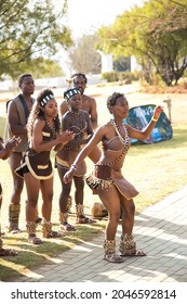 JOHANNESBURG, SOUTH AFRICA - Aug 11, 2021: A Vertical Shot Of  Traditional African Dancers Performing In Tribal Clothing And Adornments