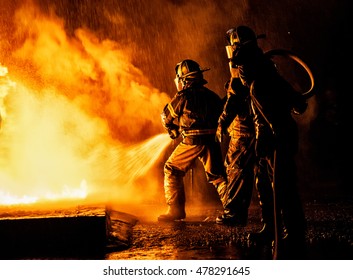 JOHANNESBURG, SOUTH AFRICA - AUGUST 26: Two firefighters fighting a fire with a hose and water during a firefighting training exercise on August 26, 2016 in Johannesburg, South Africa.