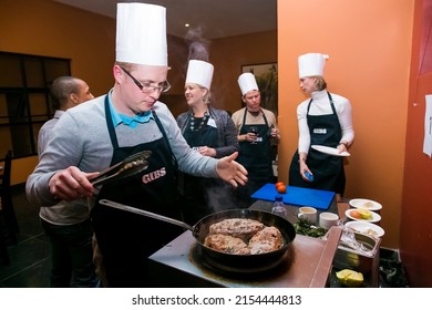 Johannesburg, south Africa - August 31, 2014: Diverse people at team building cooking class