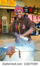 Johannesburg, South Africa, July 12, 2009,   Young African Man Cooking Mielie Pap Maize Porridge On Side Street In Urban Soweto