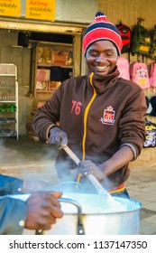 Johannesburg, South Africa, July 12, 2009,   Young African Man Cooking Mielie Pap Maize Porridge On Side Street In Urban Soweto