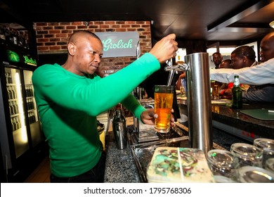 Johannesburg, South Africa - June 21, 2011: African Barman Pouring A Pint Draft Beer At Barman Training School