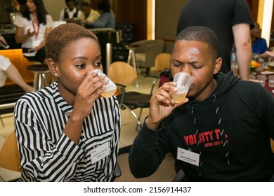 JOHANNESBURG, SOUTH AFRICA - Mar 24, 2022: A Couple Of Diverse People Participating In A Beer Tasting Competition In Johannesburg,  South Africa