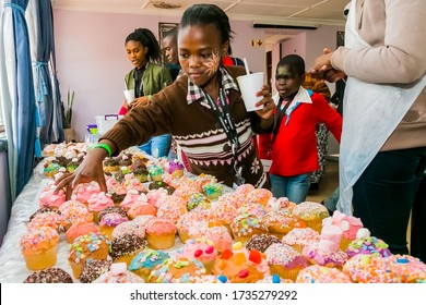 Johannesburg, South Africa - March 24, 2018: African Children Receiving Cupcakes At Soup Kitchen Volunteer Community Outreach Program At Orphanage 