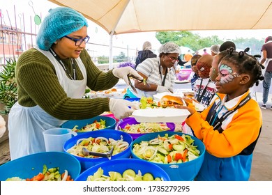 Johannesburg, South Africa - March 24, 2018: Soup Kitchen Community Outreach Catering Staff Dishing Up Meals For African Children