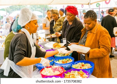 Johannesburg, South Africa - March 24, 2018: Soup Kitchen Community Outreach Catering Staff Dishing Up Meals For African Children