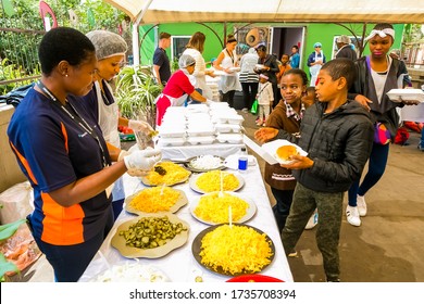 Johannesburg, South Africa - March 24, 2018: Soup Kitchen Community Outreach Catering Staff Dishing Up Meals For African Children