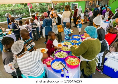 Johannesburg, South Africa - March 24, 2018: Soup Kitchen Community Outreach Catering Staff Dishing Up Meals For African Children