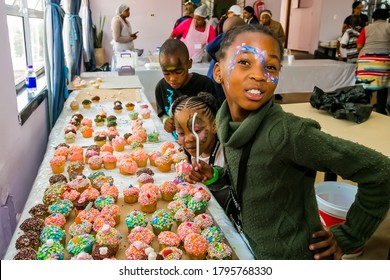 Johannesburg, South Africa - March 24, 2018: African Children Receiving Cupcakes At Soup Kitchen Volunteer Community Outreach Program At Orphanage 