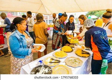 Johannesburg, South Africa - March 24, 2018: Soup Kitchen Community Outreach Catering Staff Dishing Up Meals For African Children