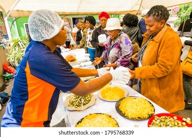 Johannesburg, South Africa - March 24, 2018: Soup Kitchen Community Outreach Catering Staff Dishing Up Meals For African Children