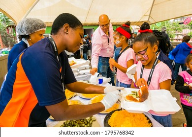 Johannesburg, South Africa - March 24, 2018: Soup Kitchen Community Outreach Catering Staff Dishing Up Meals For African Children