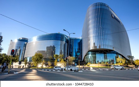 Johannesburg, South Africa - March 8, 2018: Glass Fronted Modern Building With Road In Foreground. Light Reflection On Road.
