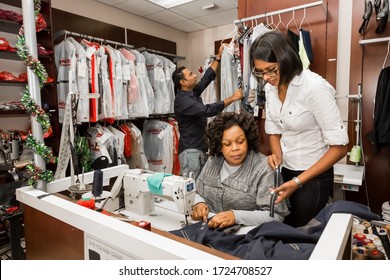 Johannesburg, South Africa - May 25, 2015: Small Business Owners Of Local Dry Cleaning Franchise Advising Staff About Clothing Repair