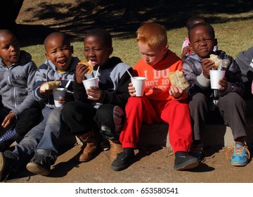 Johannesburg, South Africa - May 29, 2015: Unidentified  Needy School Children Receive Soup And Bread From A Charitable Feeding Scheme.