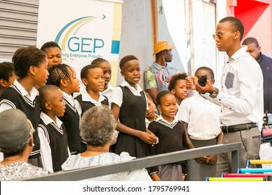 Johannesburg, South Africa - November 22, 2016: Young African Preschool Kids Singing Songs Outside Local Grocery Shop