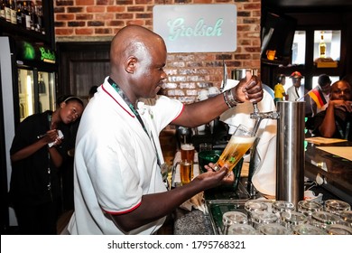 Johannesburg, South Africa - November 8, 2011: African Barman Pouring A Pint Draft Beer At Barman Training School