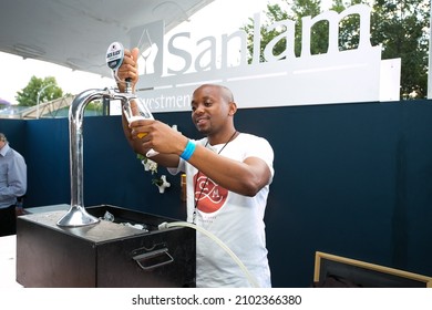 JOHANNESBURG, SOUTH AFRICA - Oct 19, 2021: An African Barman Pouring A Drink At A VIP Lounge In Johannesburg, South Africa