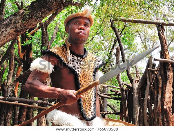 JOHANNESBURG, SOUTH AFRICA - OCT.23, 2012: A \
Zulu Warrior greets vistors to Lesedi Cultural Village. The Zulus\
are one of four South African tribes that are featured in the\
educational\
experience.
