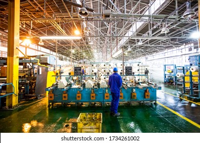 Johannesburg, South Africa - October 16, 2012: African factory worker on a copwinder weft assembly line loom