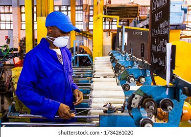 Johannesburg, South Africa - October 16, 2012: African Factory Worker On A Copwinder Weft Assembly Line Loom