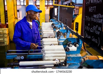 Johannesburg, South Africa - October 16, 2012: African Factory Worker On A Copwinder Weft Assembly Line Loom