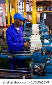 Johannesburg, South Africa - October 16, 2012: African Factory Worker On A Copwinder Weft Assembly Line Loom