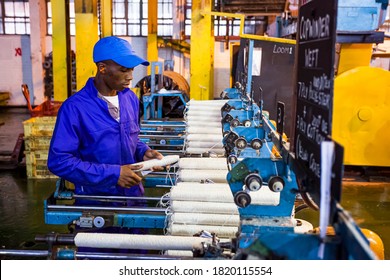 Johannesburg, South Africa - October 16, 2012: African Factory Worker On A Copwinder Weft Assembly Line Loom