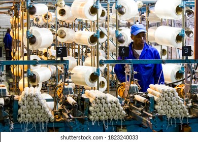 Johannesburg, South Africa - October 16, 2012: African Factory Worker On A Copwinder Weft Assembly Line Loom