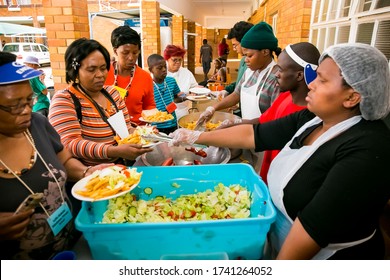 Johannesburg, South Africa - October 9, 2014: Soup Kitchen Community Outreach Catering Staff Dishing Up Meals For African Women