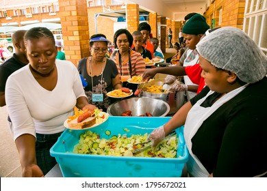 Johannesburg, South Africa - October 9, 2014: Soup Kitchen Community Outreach Catering Staff Dishing Up Meals For African Women